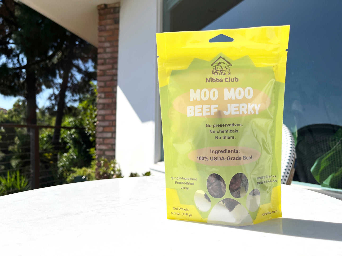 Moo Moo Beef Jerky dog treat on a table outside